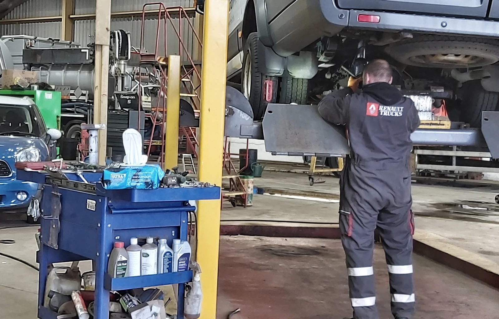 Mechanic using UltraGrime wipes in a workshop